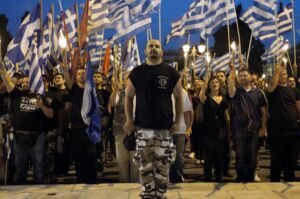 Members and supporters of the ultra-nationalist Golden Dawn party chant the national anthem in front of the Greek parliament in central Athens