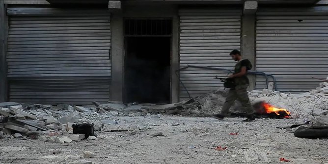 rsz free syrian army soldier walking among rubble in aleppo