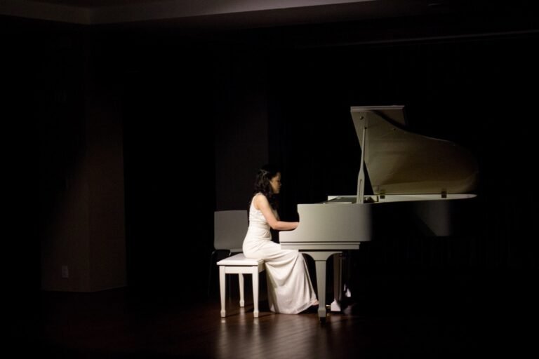 woman playing grand piano 1293551