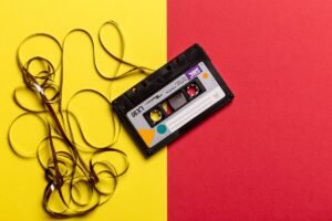 black cassette tape on top of red and yellow surface 1626481