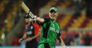 An Irish batsman celebrating with an English player in the background