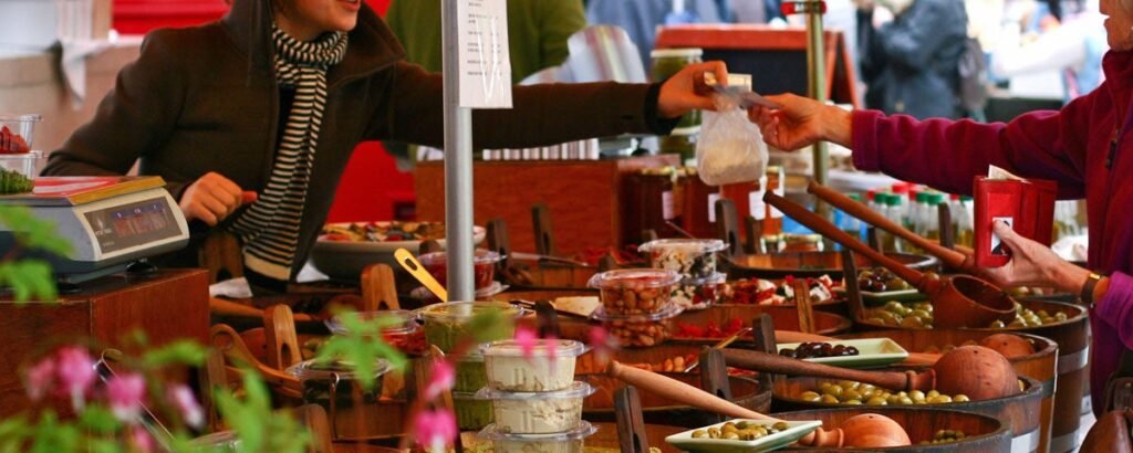 display of olives and other fresh foods being sold at food market