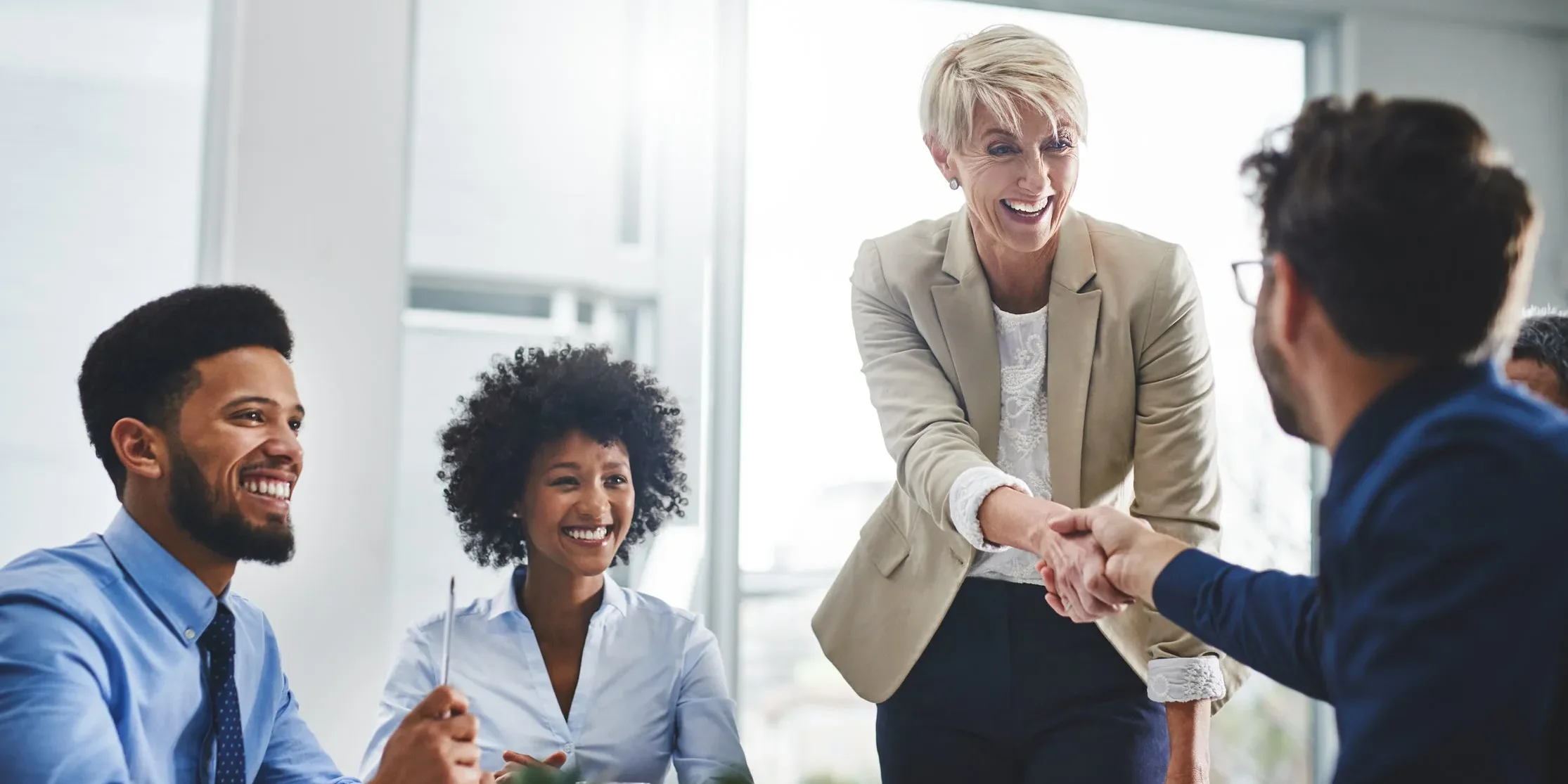 Netherlands Networking & Professional Growth Guide 1 four people in an office shaking hands e1752228216642